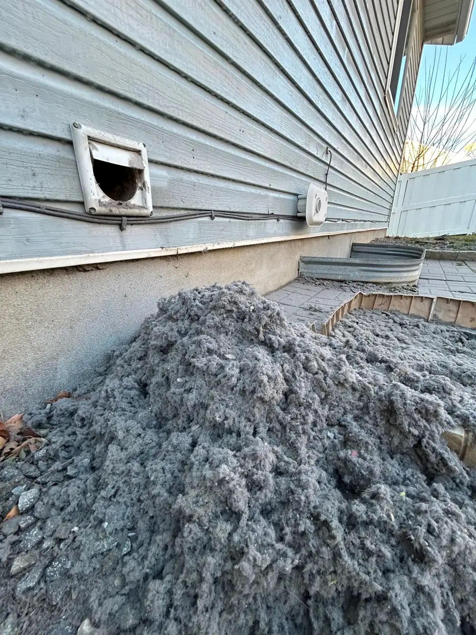 A pile of lint pulled out of a clogged dryer vent