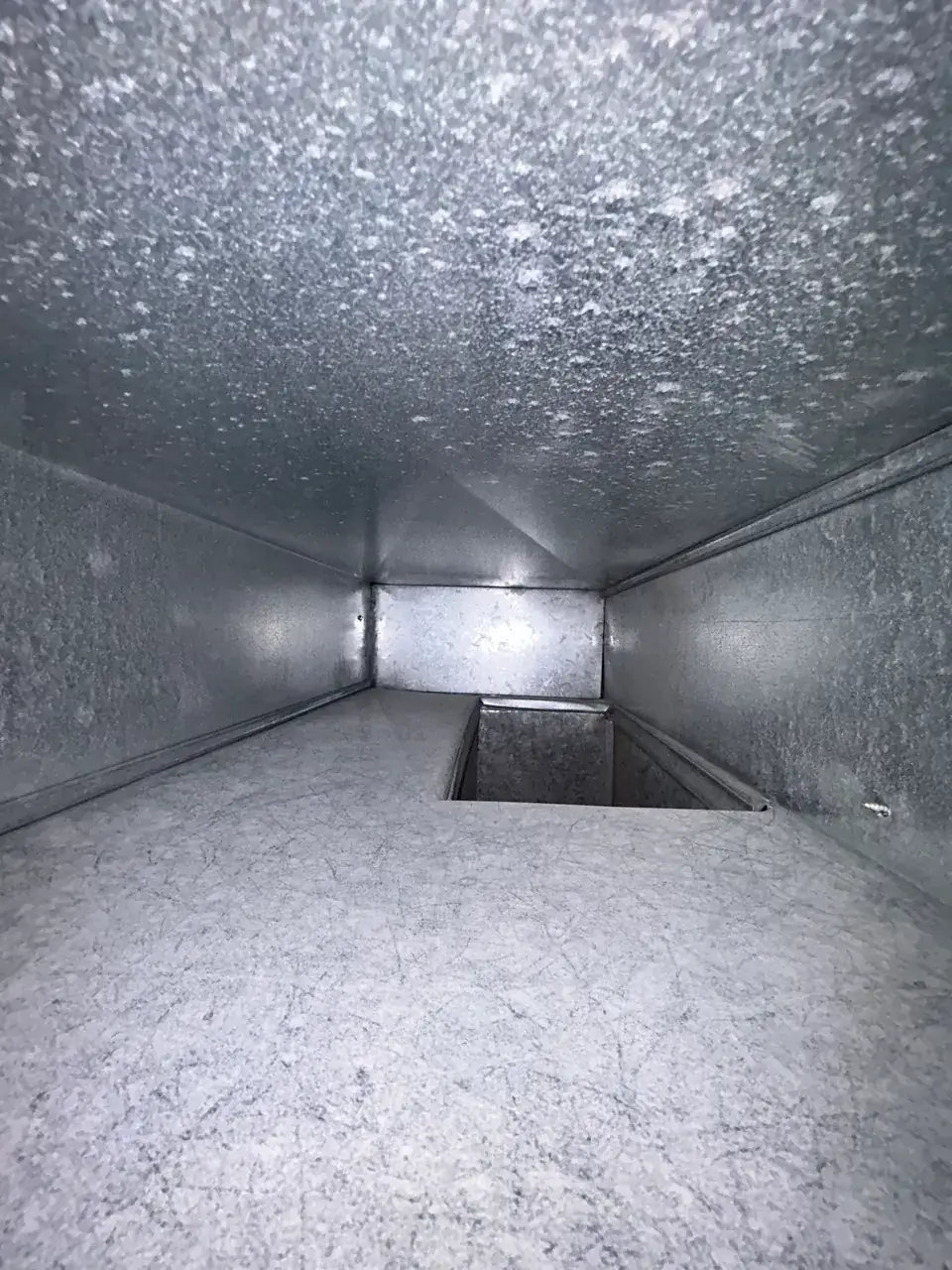After: the same duct cleaned down to bare metal